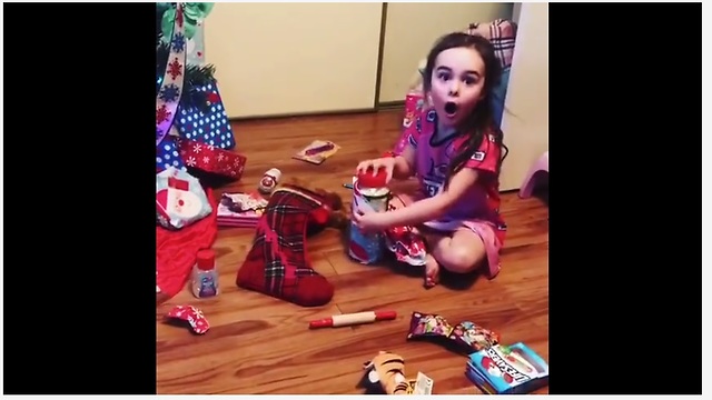 Little girl absolutely thrilled to receive Parmesan cheese for Christmas!