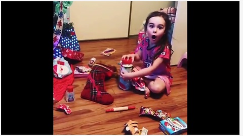 Little girl absolutely thrilled to receive Parmesan cheese for Christmas!