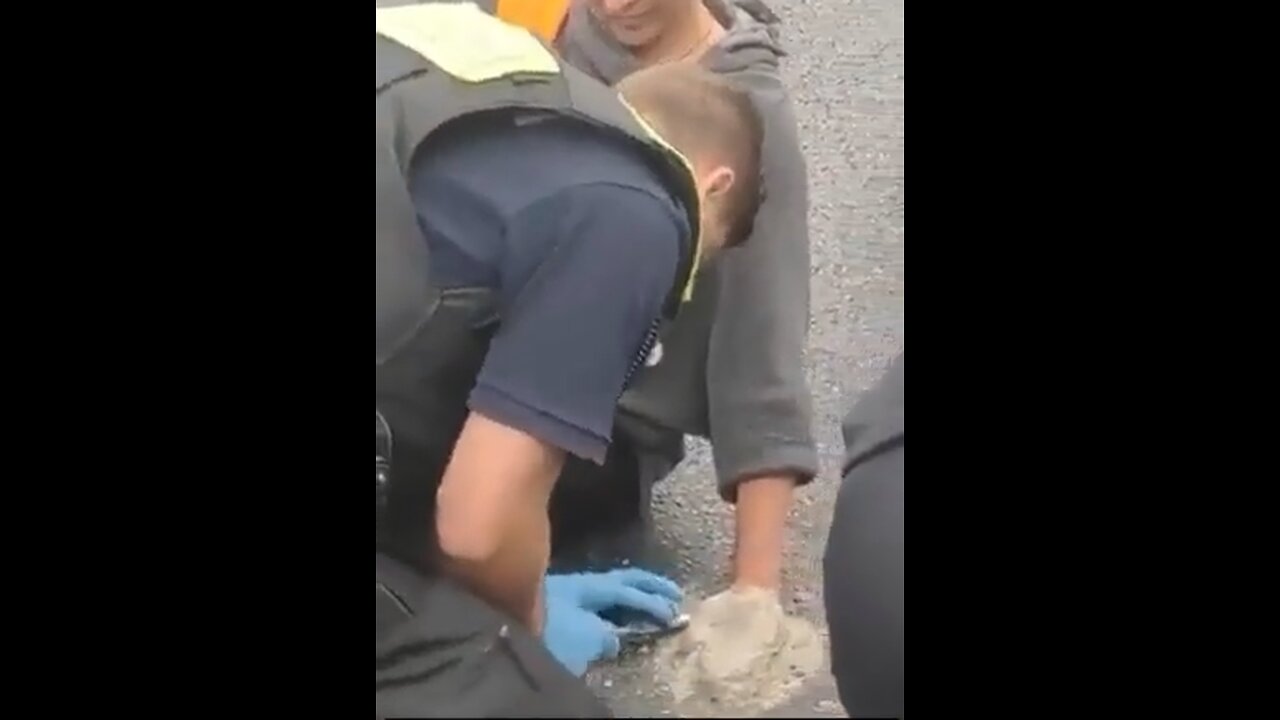 Climate activist glues herself to the road with cement to protest climate change