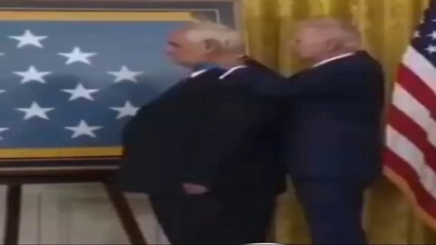 Biden puts the medal backwards is that a medal or a collar