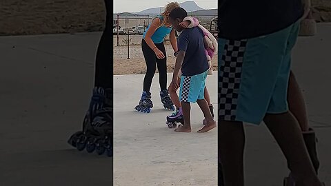 TJ helping Tasha learn to skate.