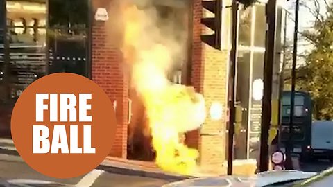 This dramatic footage shows flames bursting out of a manhole cover on a busy city street.