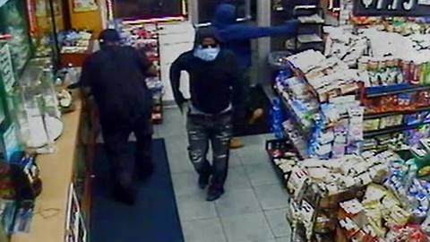 Surveillance video shows two men wanted in Detroit gas station murder