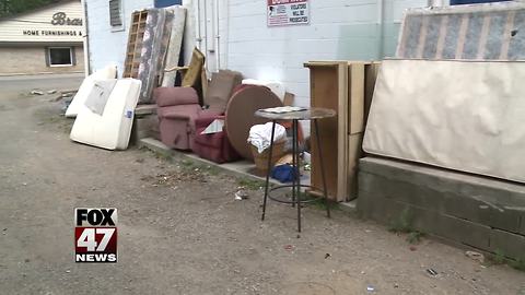 Non-profit fed up with people dumping trash behind building