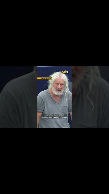 Mick Wallace stands with Julian Assange