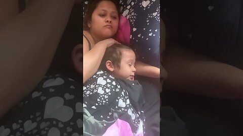 Beautiful mommy and her baby boy are watching something on the phone