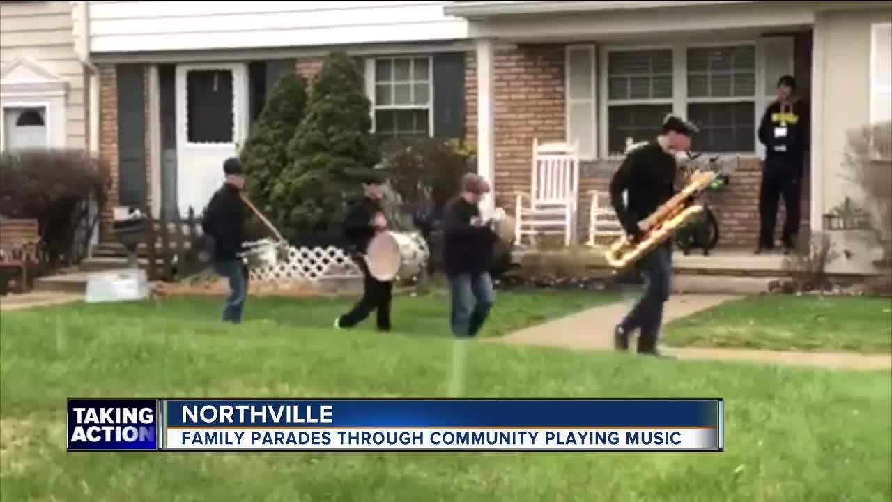 Family parades through community playing music