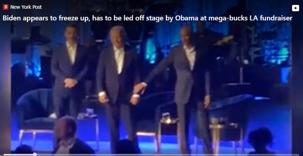 Frozen Briben led off stage by Barack Obama by the hand