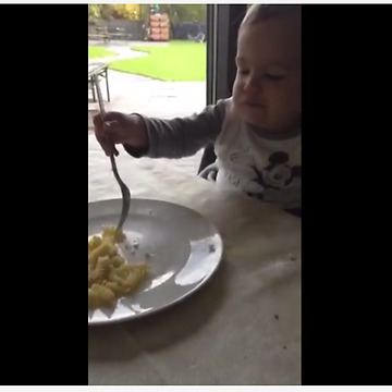 Toddler Takes Real Delight Into Munching Macaroni With Two Forks