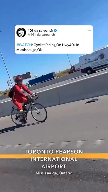 Cyclist riding bike in Highway 401 Toronto