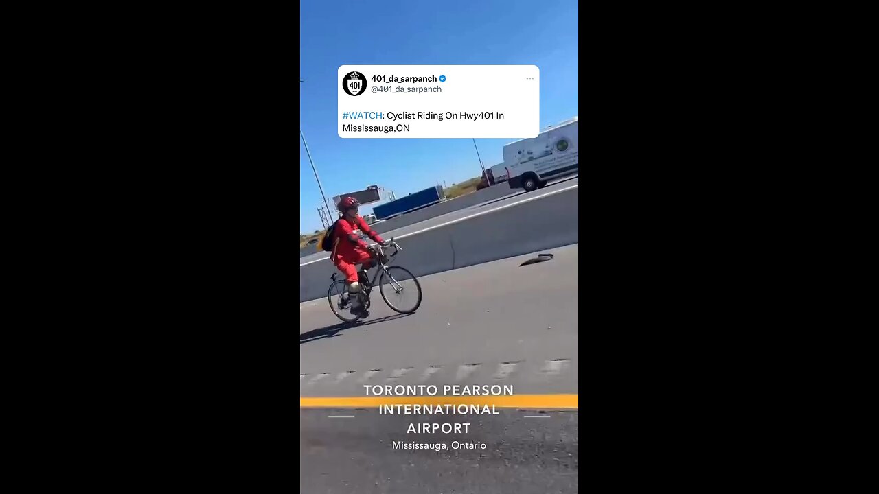 Cyclist riding bike in Highway 401 Toronto