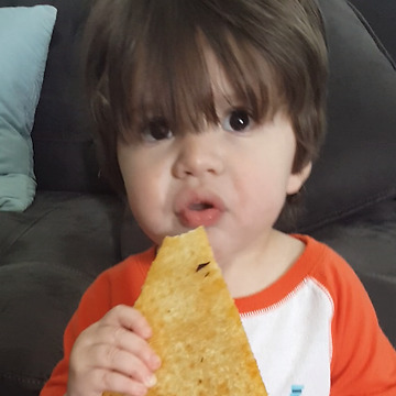 An Adorable Boy Steals A Pizza Slice