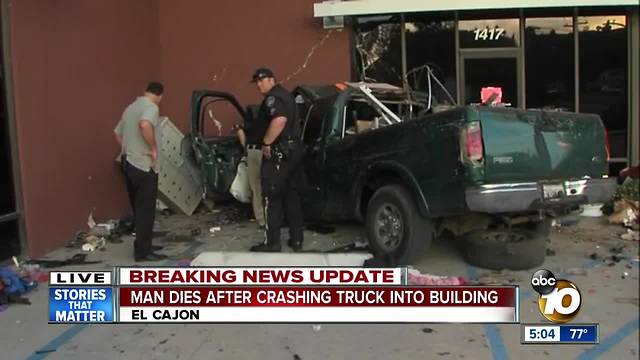 Man dies after crashing truck into building