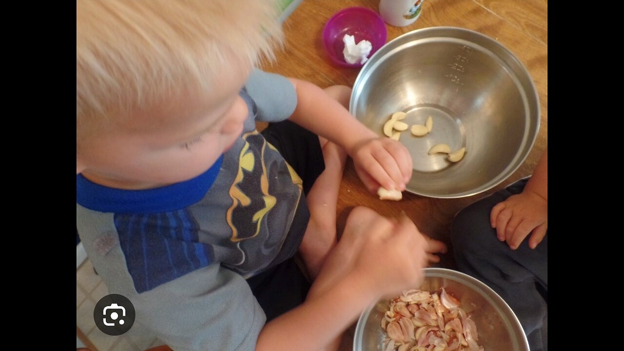 Little Chef, Helping Out Mom, Peeling Garlic with a Smile.