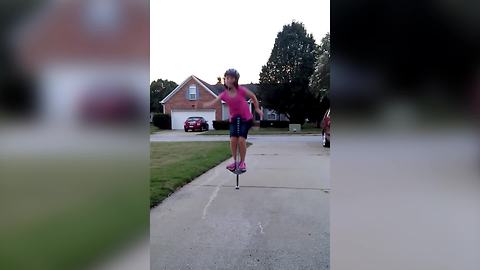 Young Girl Jumps On A Pogo Stick With No Hands