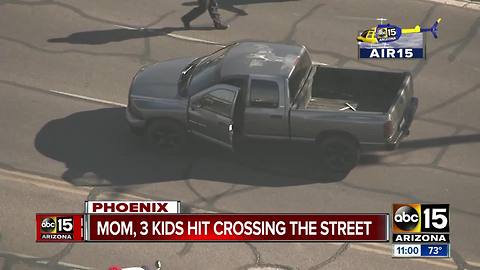 Mom, three kids by vehicle in Phoenix