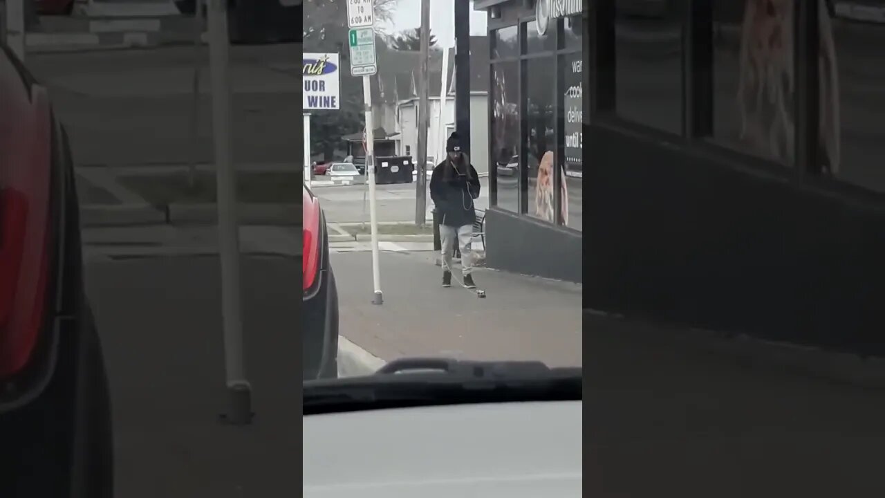 Just a dude walking his toy car.