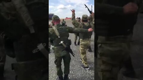 Fighters from Dagestan dance at the airfield before being sent to combat coordination