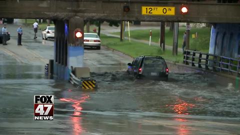 Heavy rain floods road in Lansing