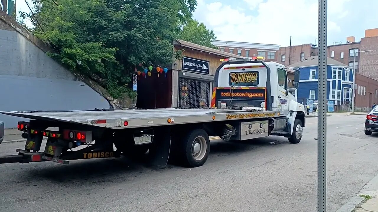 U-Haul with a broken drive shaft being towed