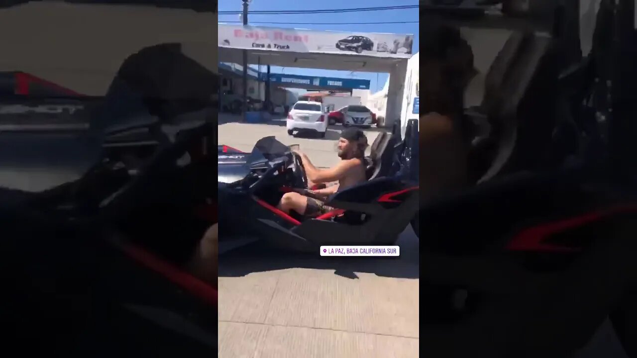 Jorge Mavidal driving three wheeled car on a test drive