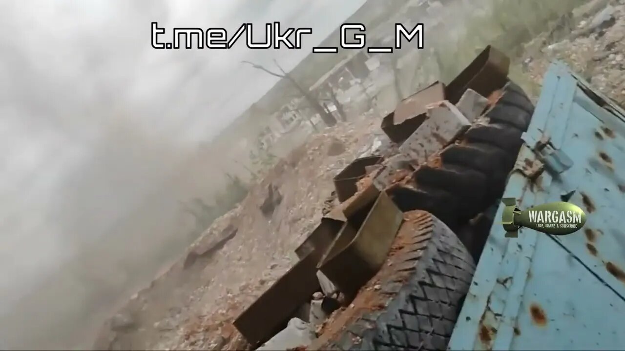 Ukrainian soldiers duck as their position almost suffers a direct hit