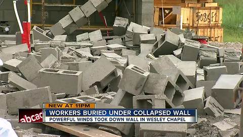 Cinder block wall collapses on construction workers taking refuge from thunderstorm