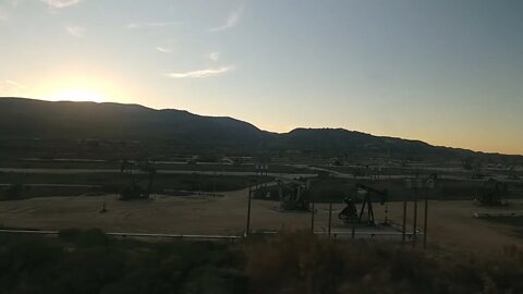 Oil derricks and sunset from the Amtrak Coast Starlight