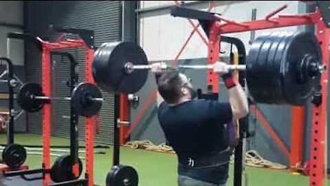 Strongman falls backwards doing overhead press