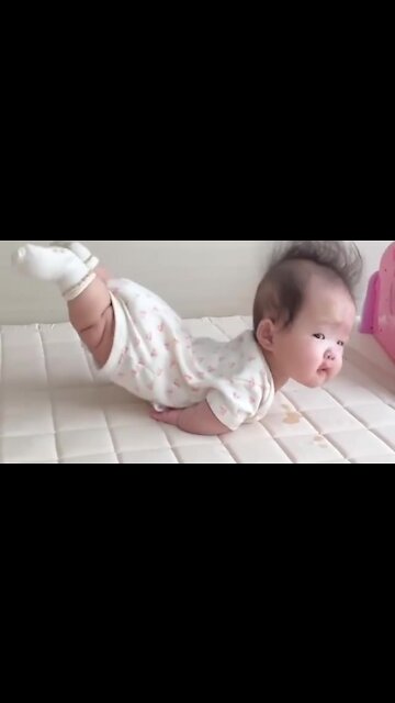 Toddler hilariously lays with her legs in the air