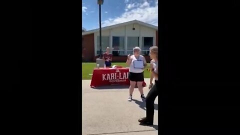 Woman with rainbow flag trolls Students for Kari Lake
