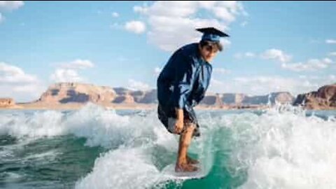 Graduate rides wakeboard in stylish end of course photo op!