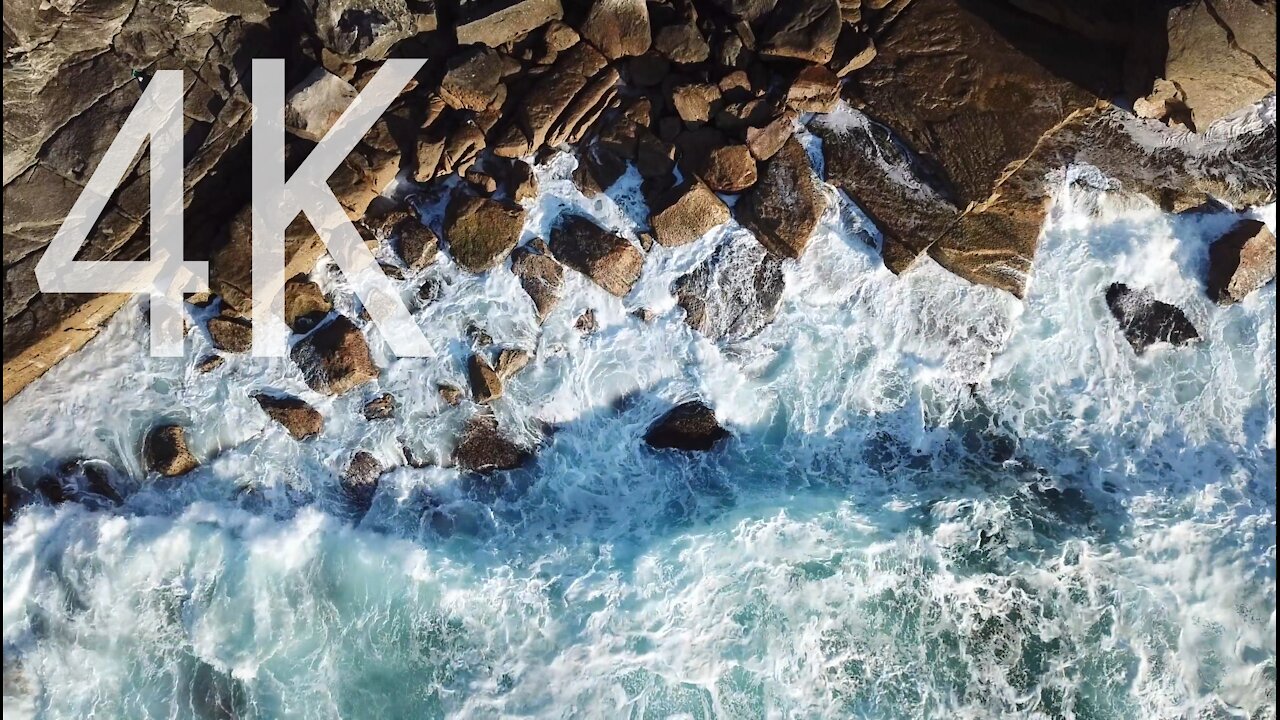 Sea waves crashing on the rocks creates the foam of the white sea High quality