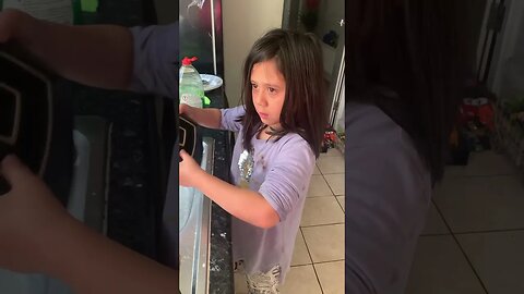 Hard working little girl is washing dishes