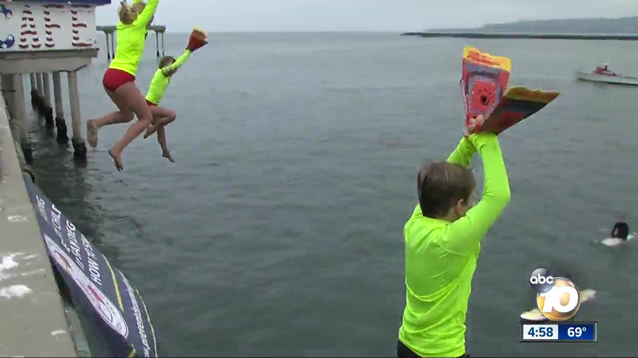 Kids jump off Ocean Beach pier