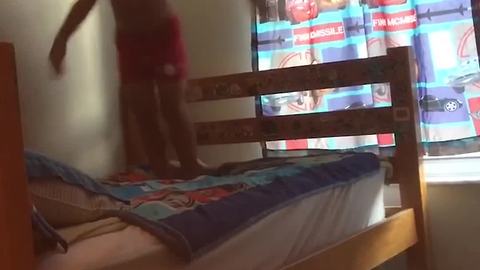 Happy Kid Jumps On Bed