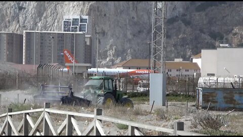 John Deere Tractor makes an Appearance in front of Plane; A320 Departing from Gibraltar