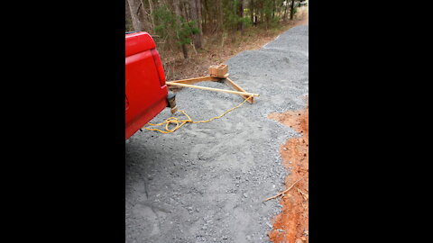 Leveling piles of gravel in driveway