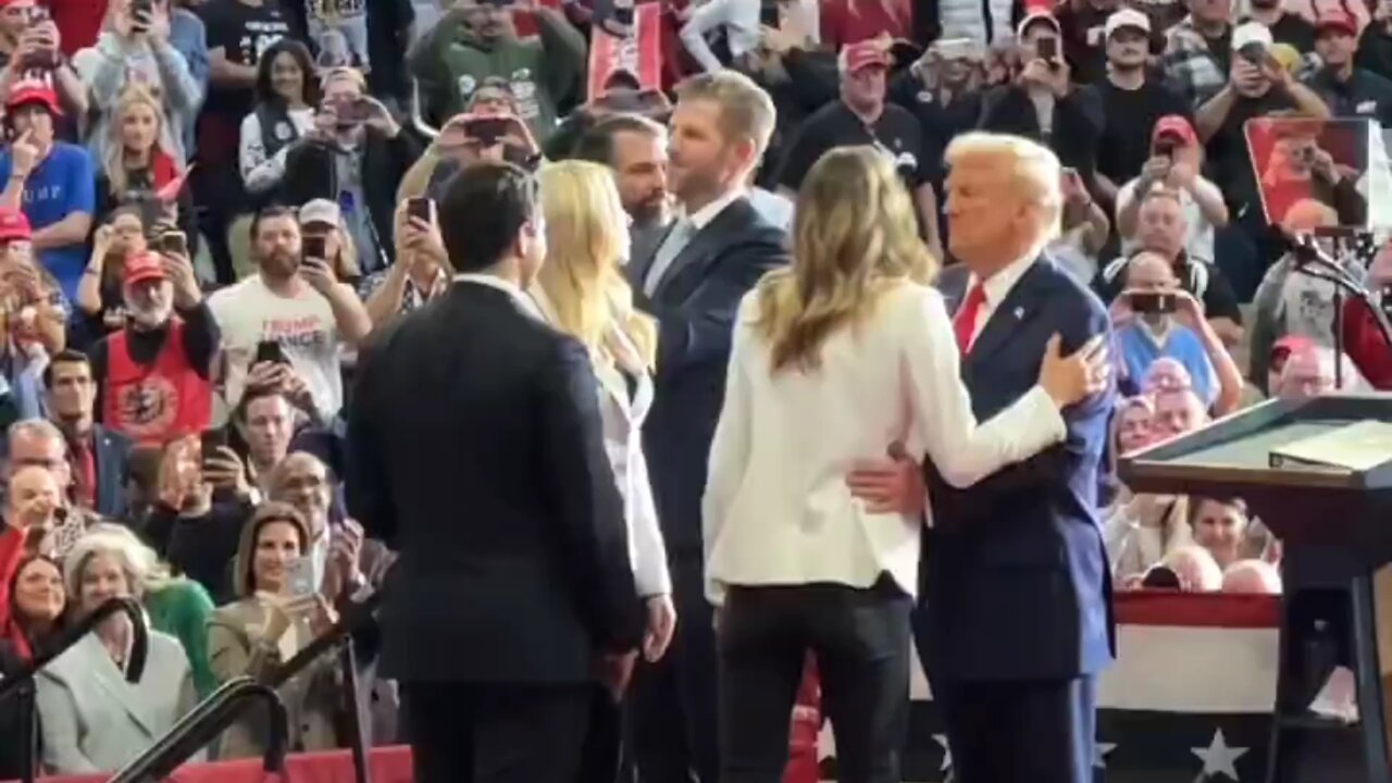 President Trump takes a woman's kiss while greeting her