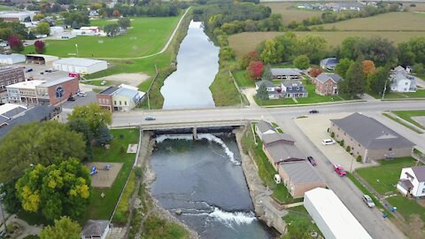 Drone view following along river and falls