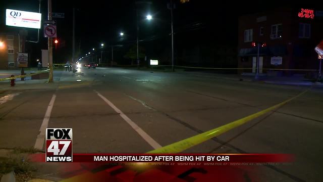 Man crossing street hit by truck, critically injured