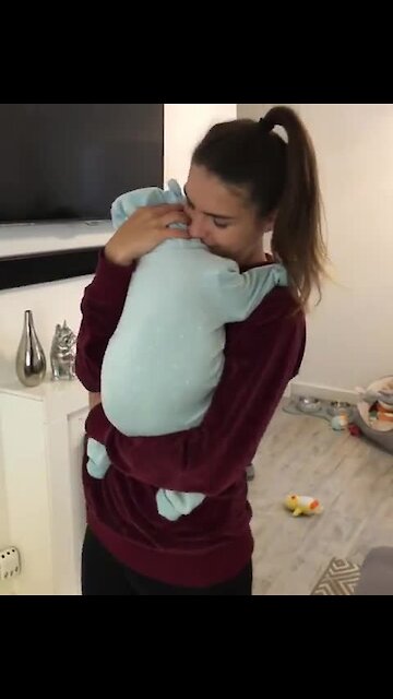 She appears to be holding a baby, but just wait for it!