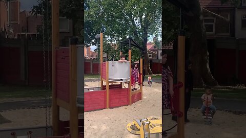 Baby boy and his big sisters play in the park