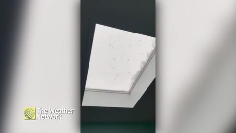 Hail loudly pounds skylight during storm