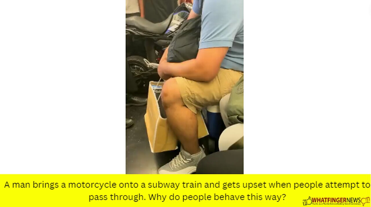 A man brings a motorcycle onto a subway train and gets upset when people attempt to pass through.