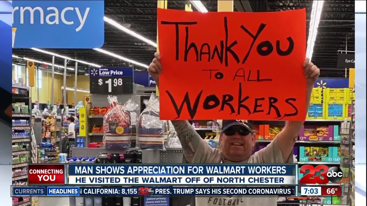 Man thanks Walmart employees with sign