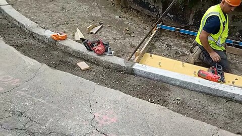 construction workers repairing the sidewalk on batchelder Street