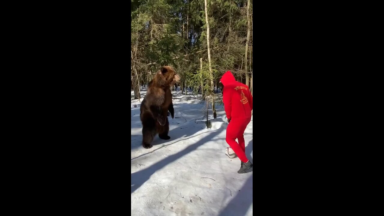 Guy playing Soccer with Bear