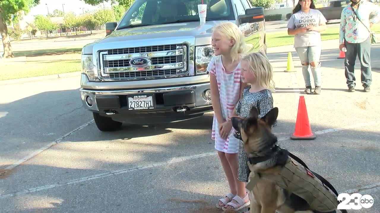 Community members accept dog food donations for local shelters in honor of K-9 Officer Jango