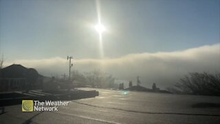 Beaming sun illuminates massive cloud over water